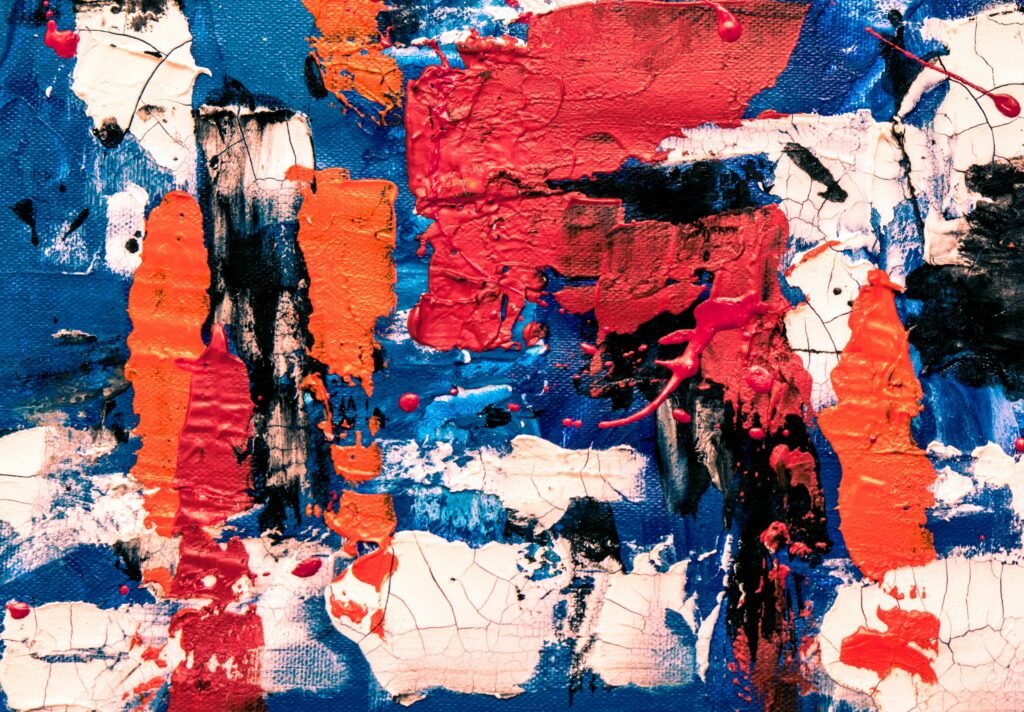 Dynamic abstract painting featuring bold red, blue, and orange colors, creating an expressive artistic texture.